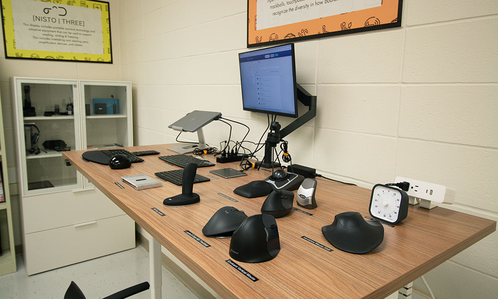 desk full of ergonomic mice for computers