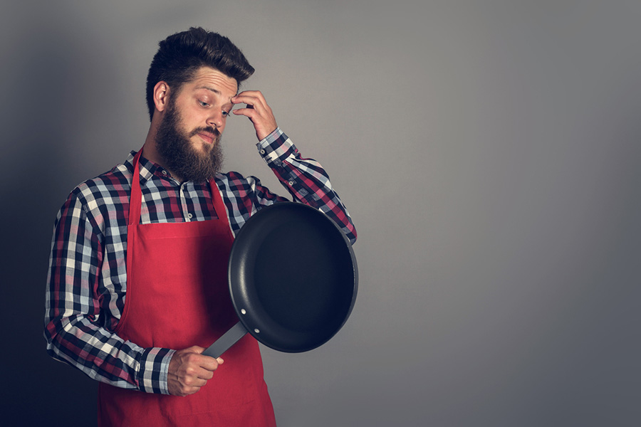 dude staring at frying pan before cooking