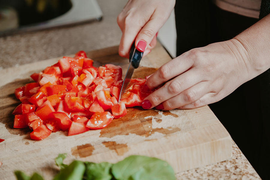 woman chopping tomatoes