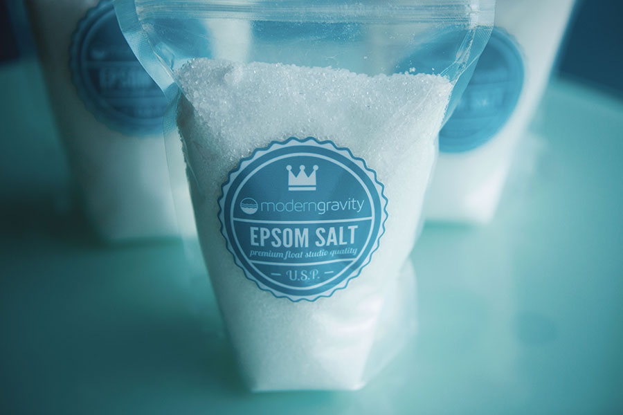 Clear plastic package of Modern Gravity epsom salts with blue circular label