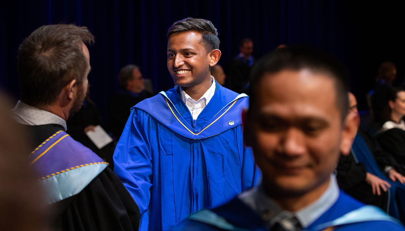 nait jr shaw school of business school students cross the stage at convocation 2022