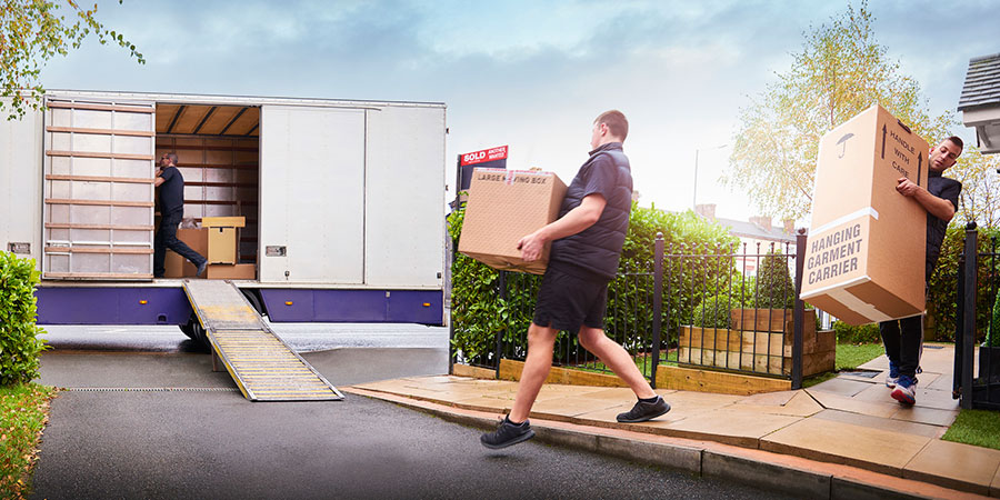 movers moving things out of home into moving van
