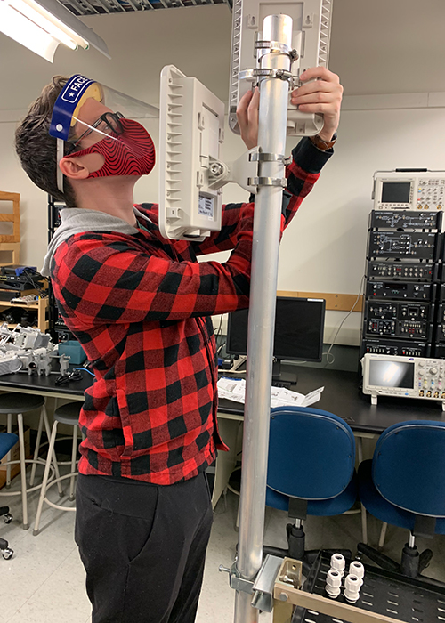 nait wireless systems student Spencer Tracy assembles an antennae