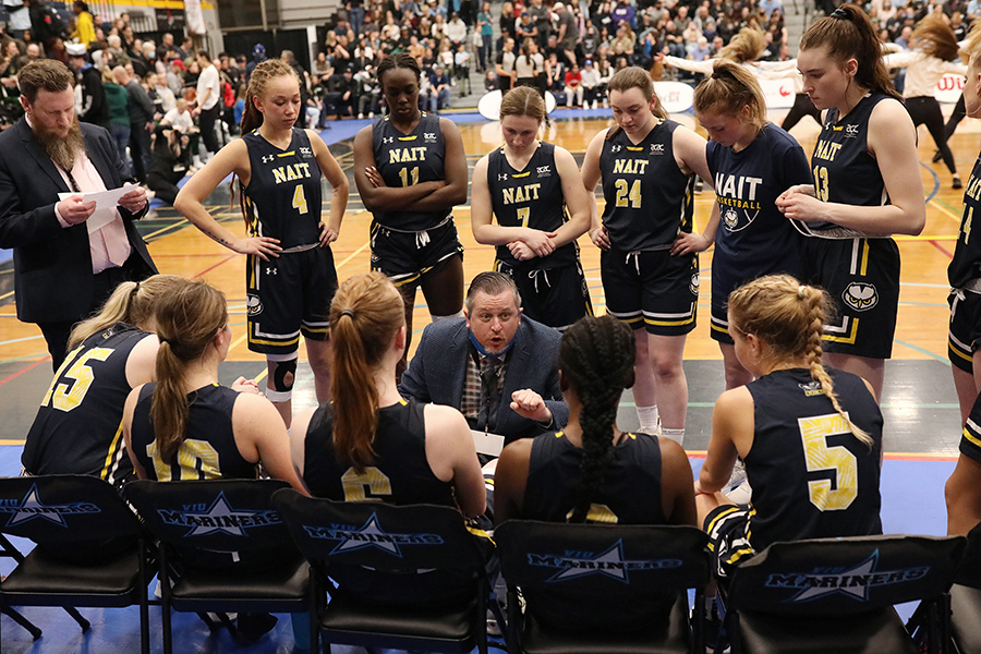 nait women's basketball team listen to coach todd warnick at CCAA finals 2022