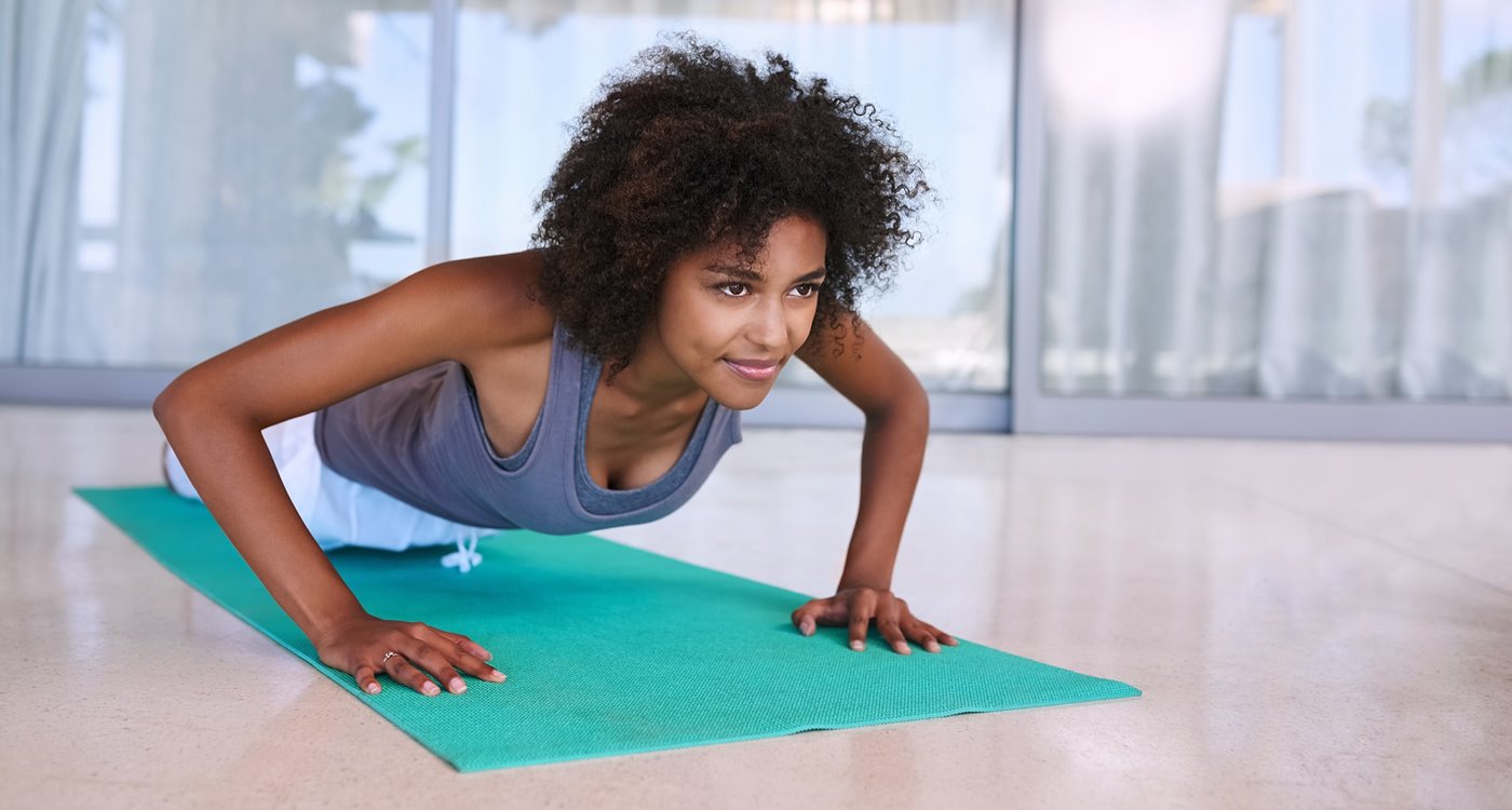 woman working out at home with yoga mat